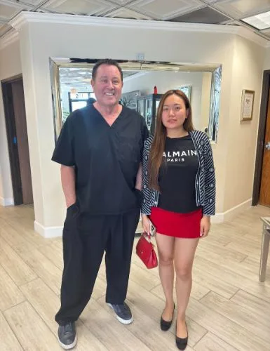 A client with founder James Hooper in the studio hallway