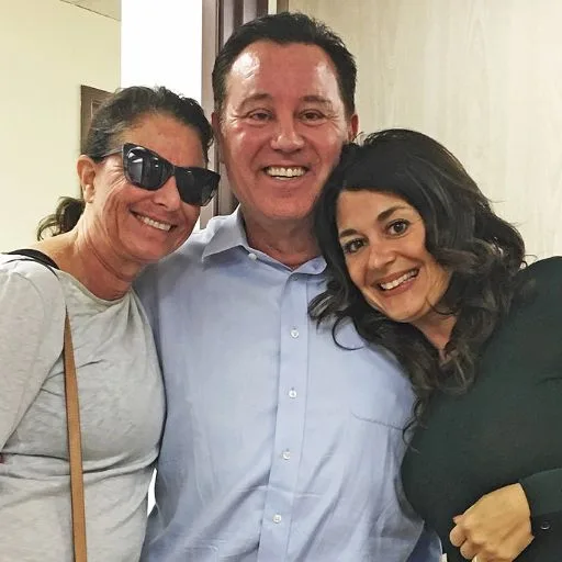 James Hooper with two smiling clients in a group selfie