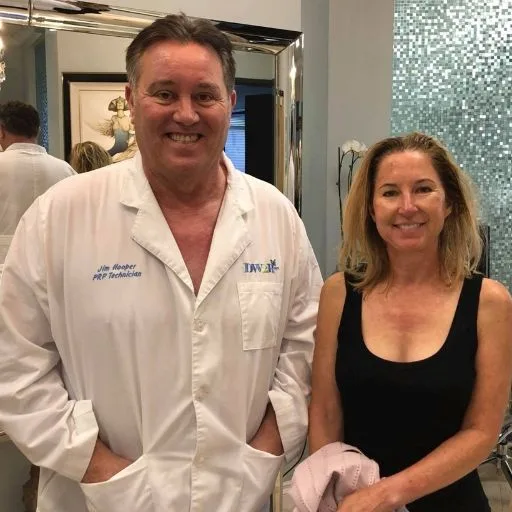 James Hooper in his lab coat with a client after her visit