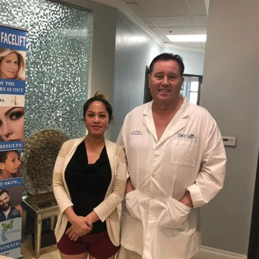 A client with James Hooper next to the Butterfly Facelift banner