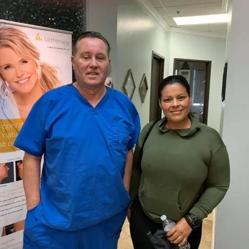 A smiling client with James Hooper after her appointment