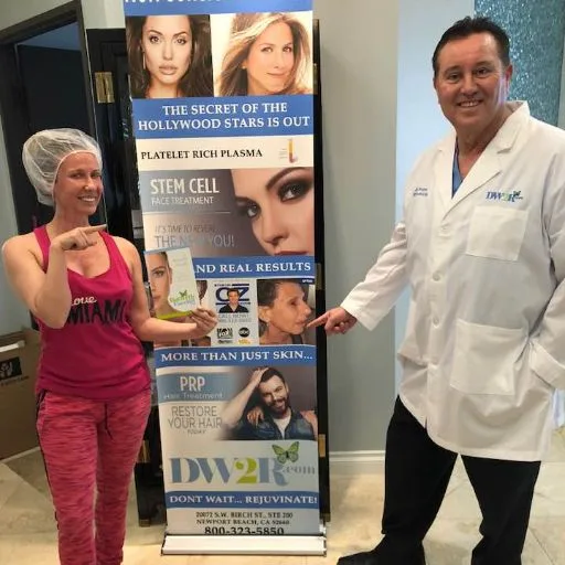 A client in a hair cap beside the treatment banner during her visit