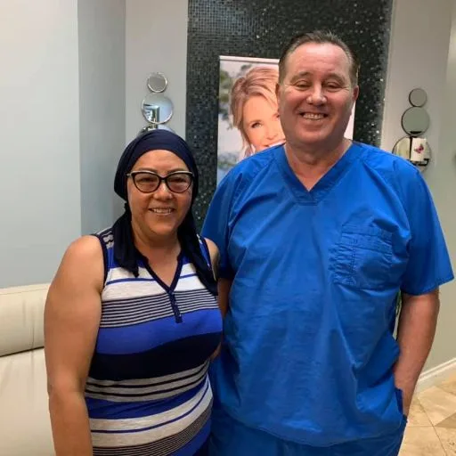A client in a striped top with James Hooper