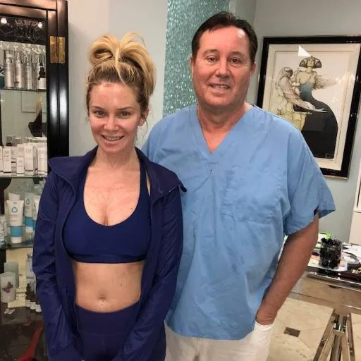 A client in activewear with James Hooper after her session