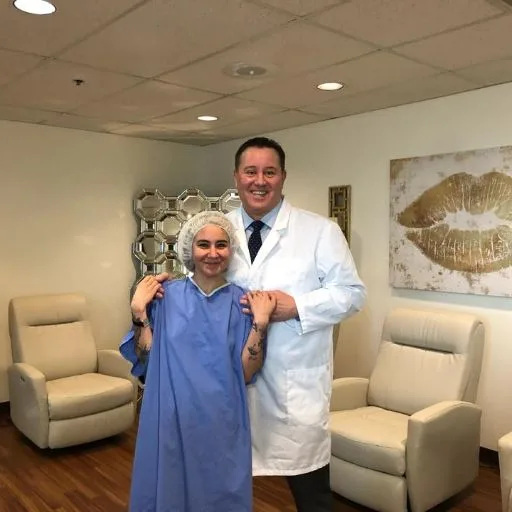 A client in a treatment gown with James Hooper before her session
