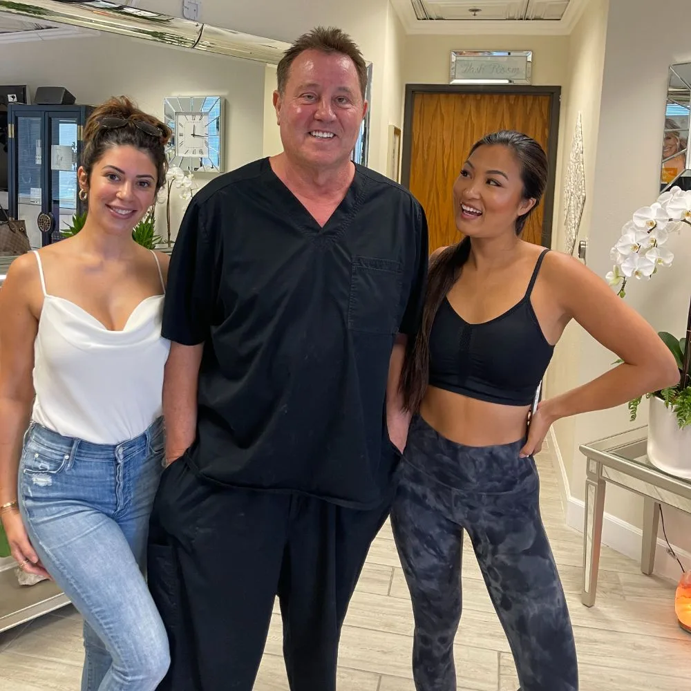 James Hooper with two clients in activewear