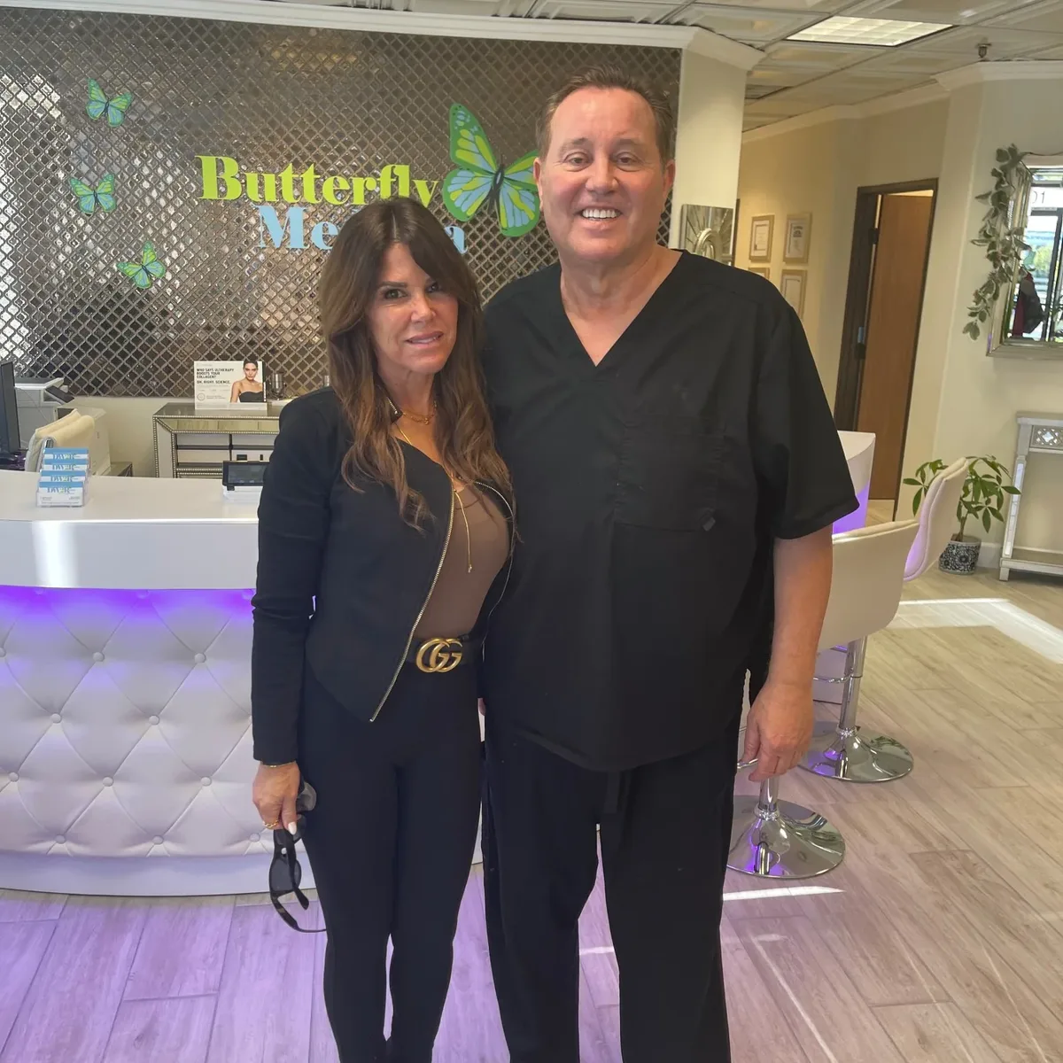 James Hooper with a client at the Butterfly MedSpa reception desk