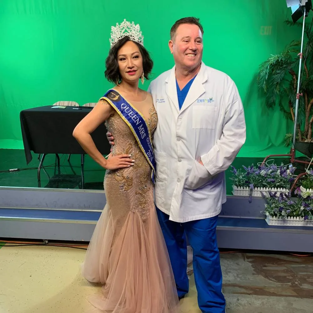 James Hooper with a beauty queen in her tiara on a photo set