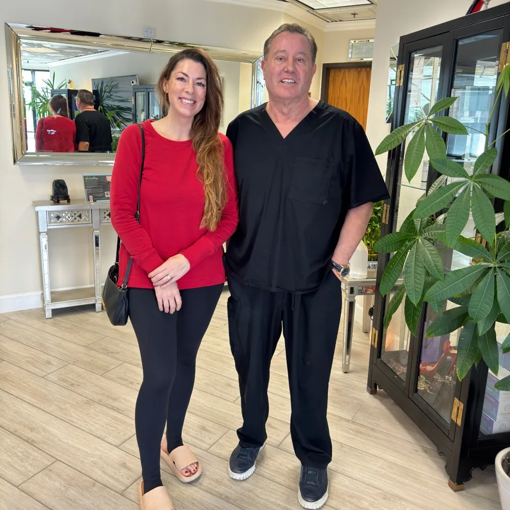 A client in a red sweater with James Hooper