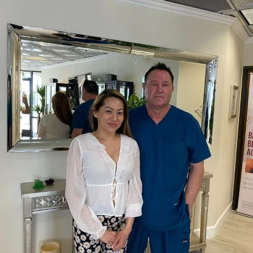 A client in a white blouse with James Hooper by the mirror