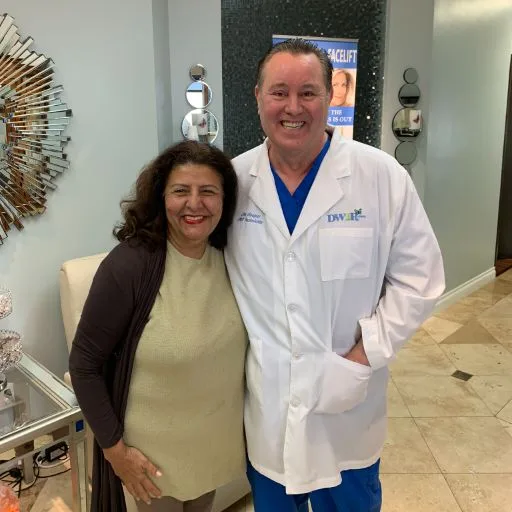 James Hooper in his lab coat with a client at the studio
