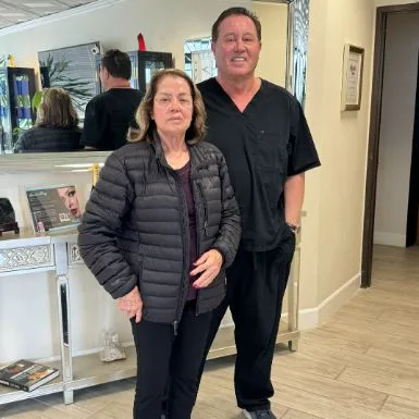 A client in a dark jacket with James Hooper