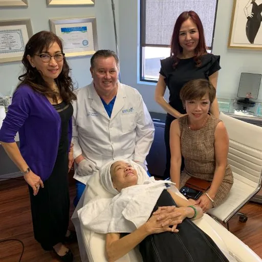 James Hooper with a client's family in the treatment room