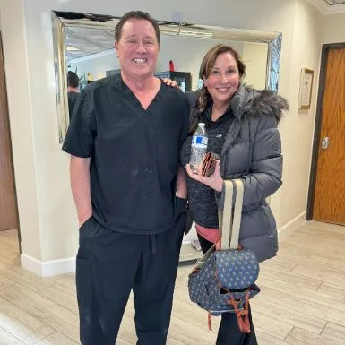 A client in a winter coat with James Hooper