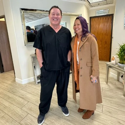 A client in a mustard coat with James Hooper