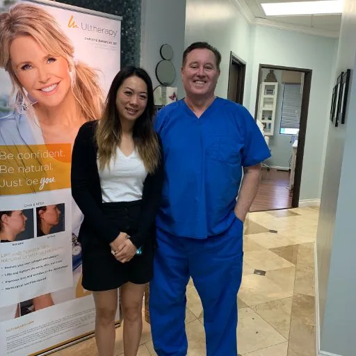 A client in a blazer with James Hooper by the treatment banner