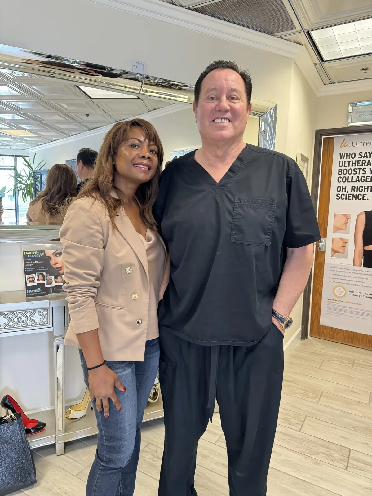 A client in a beige jacket with James Hooper in the office
