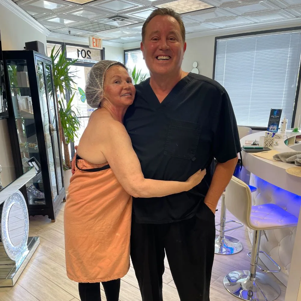 A client wrapped in a towel with James Hooper right after treatment