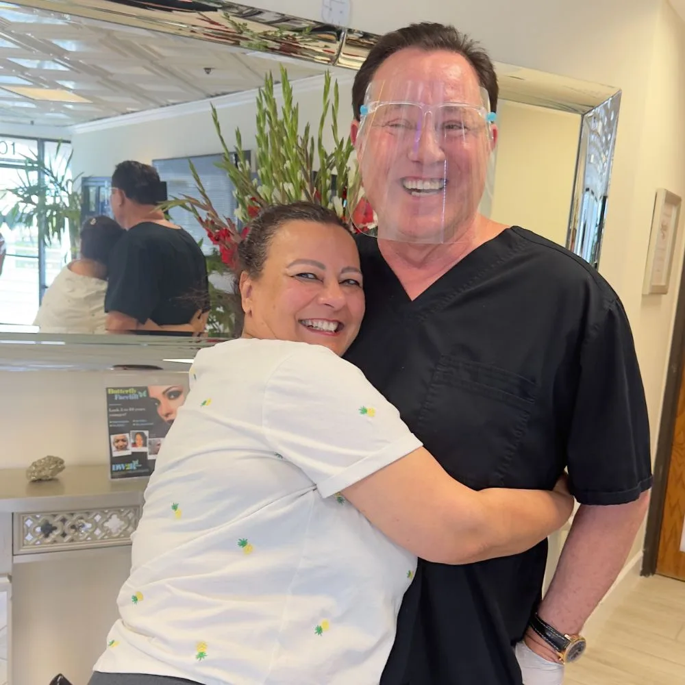 A client giving James Hooper a playful hug