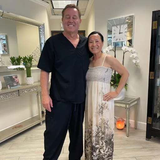 A client in a patterned dress with James Hooper