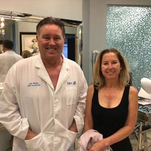 James Hooper in his lab coat with a client after her visit