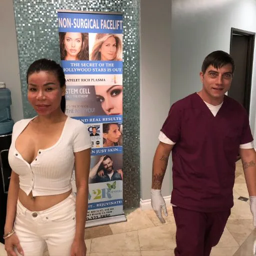 A client with a team member beside the treatment banner