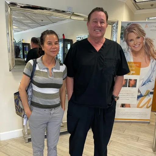 A client with a backpack with James Hooper by the treatment banner