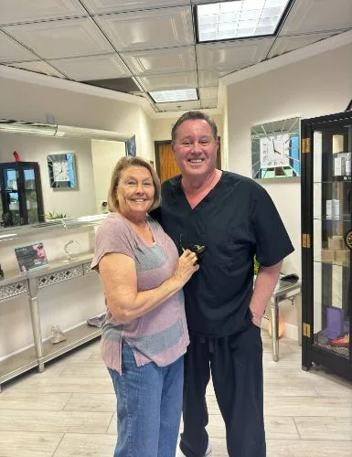 A client in a gray top with James Hooper by the display