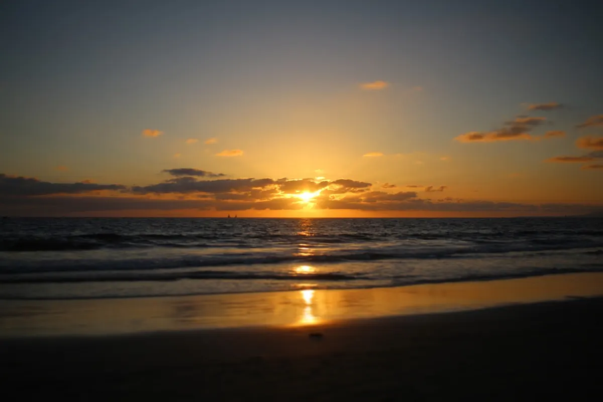 Sunset over the ocean from the beach near Corona del Mar and Newport Beach