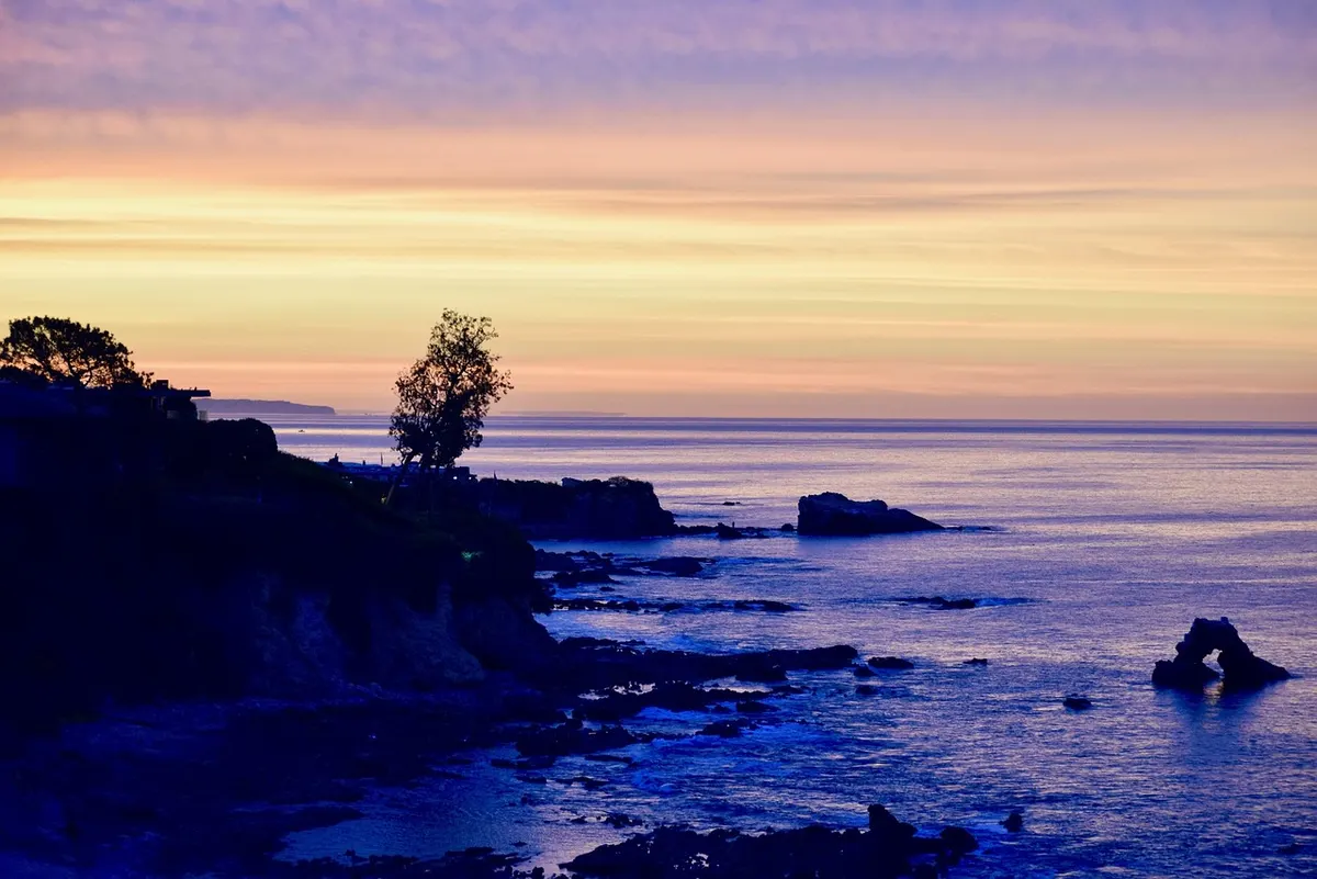 Rocky cove and arch rock at sunset along the Corona del Mar coastline