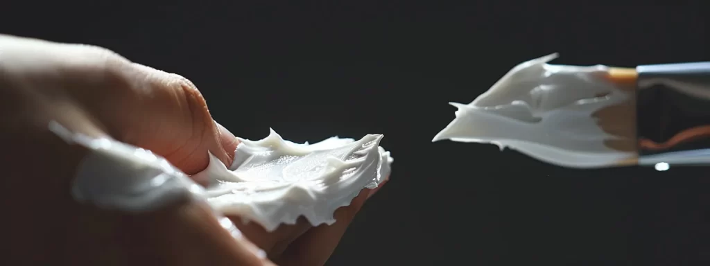 a hand holding a cotton applicator, evenly applying a diy skin tightening mask on a smooth, glowing skin.