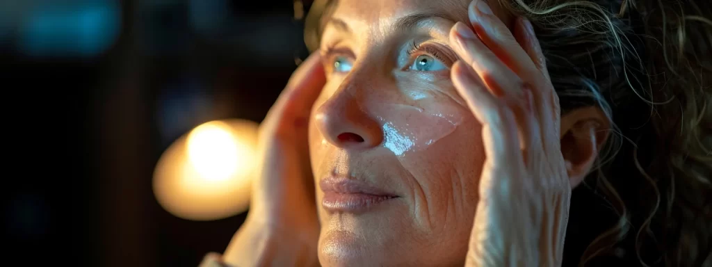 a woman gently applying soothing moisturizer to her rejuvenated and firmer skin after laser skin tightening treatment.